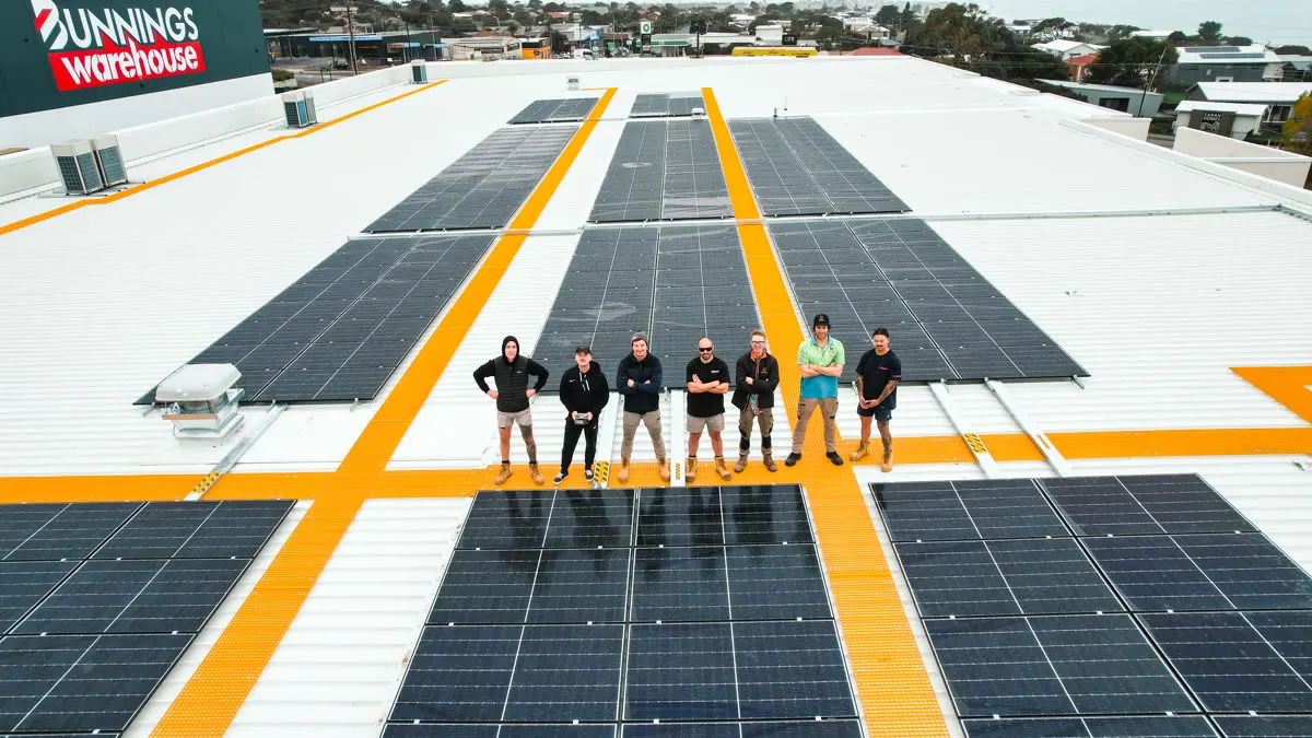 The Deionno crew standing on a finished commercial solar array on a Bunnings Warehouse roof